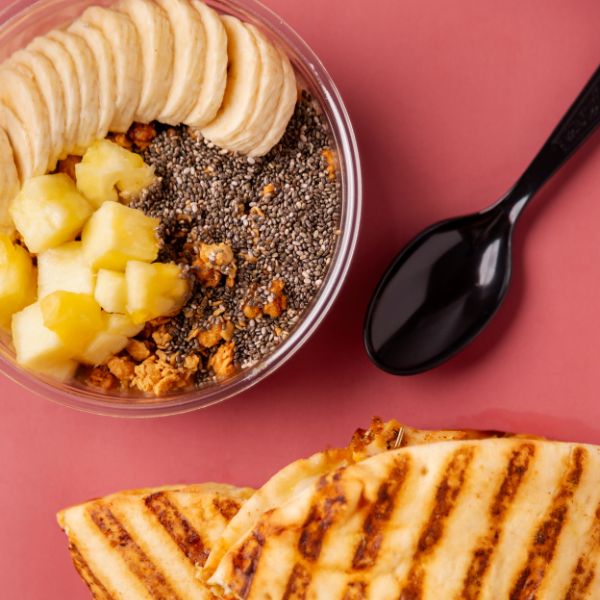 Bango Bowls a&ccedil;a&iacute; bowl topped with banana, mango, chia seeds, and granola