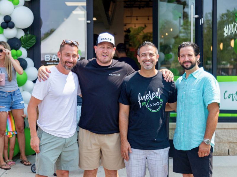 Group of Bango Bowls franchise owners smiling outside a new location at grand opening